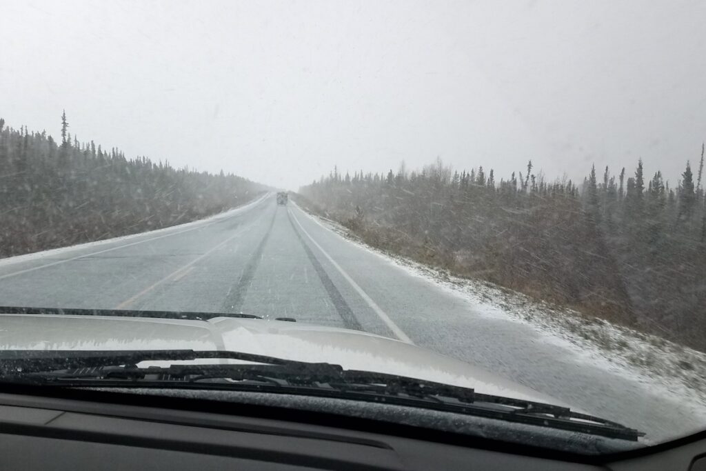 Driving through a snow squall on the Alaska Highway in May.