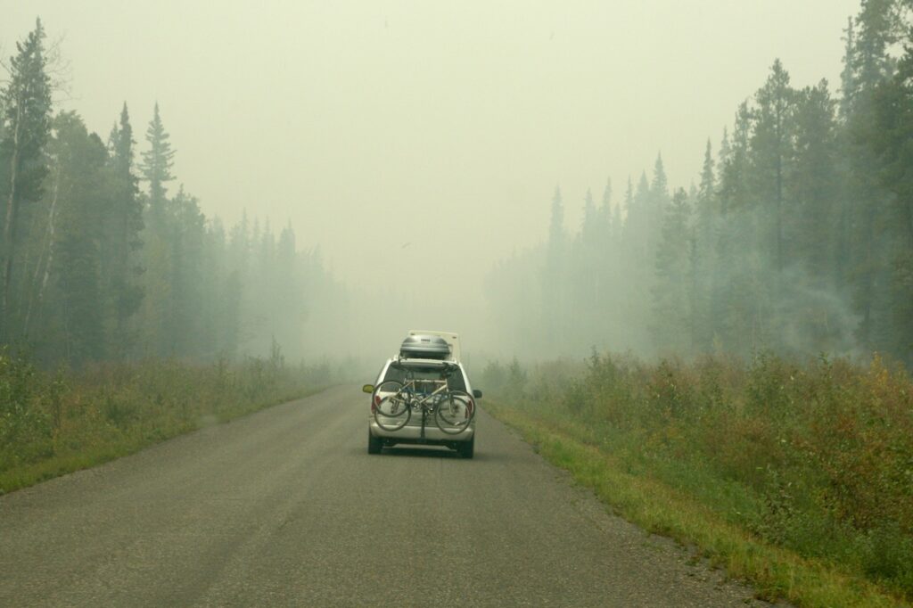 Smoky conditions driving on Cassiar Highway behind another vehicle.