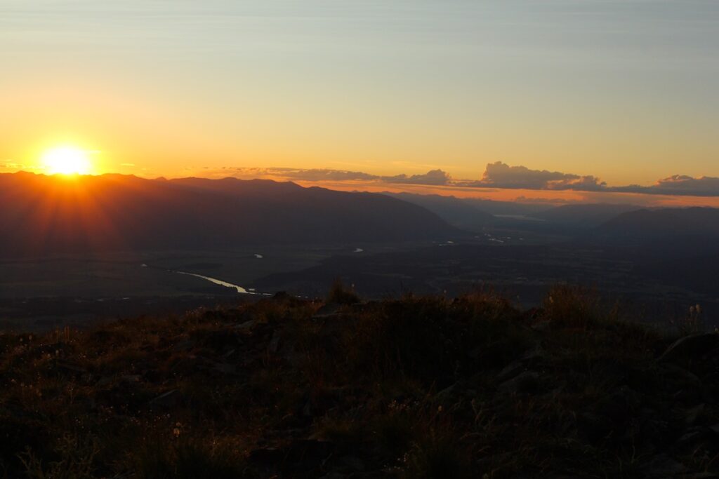 Sun setting over Selkirk Mountains on summer solstice